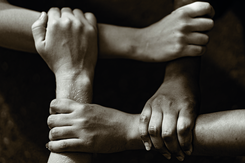 Multiracial people with black, latin, caucasian and asian hands / Manpeppe - stock.adobe.com Multiracial people with black, latin, caucasian and asian hands holding each other wrist. Unit and concord in multiethnic team. Tolerance, teamwork and anti racism concept. Image